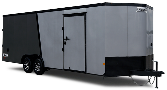 Gray enclosed cargo trailer with a side door, dual axles, and a hooked hitch on the front-right; trailer is on a flat surface.